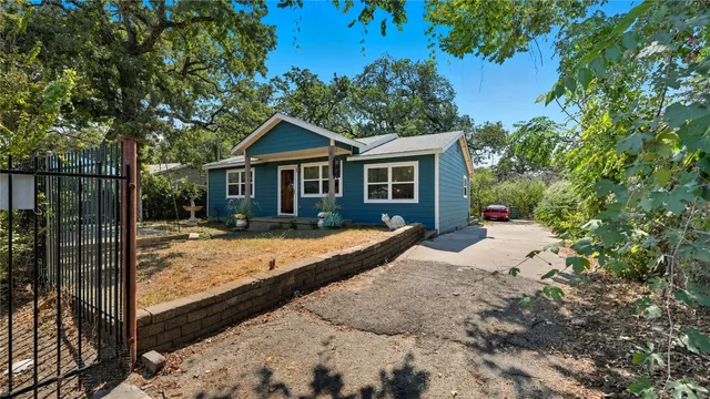 a view of a house with a backyard and garden
