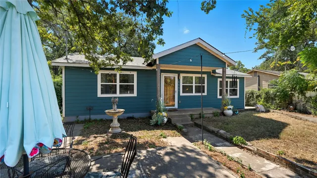 a view of a house with yard and sitting area