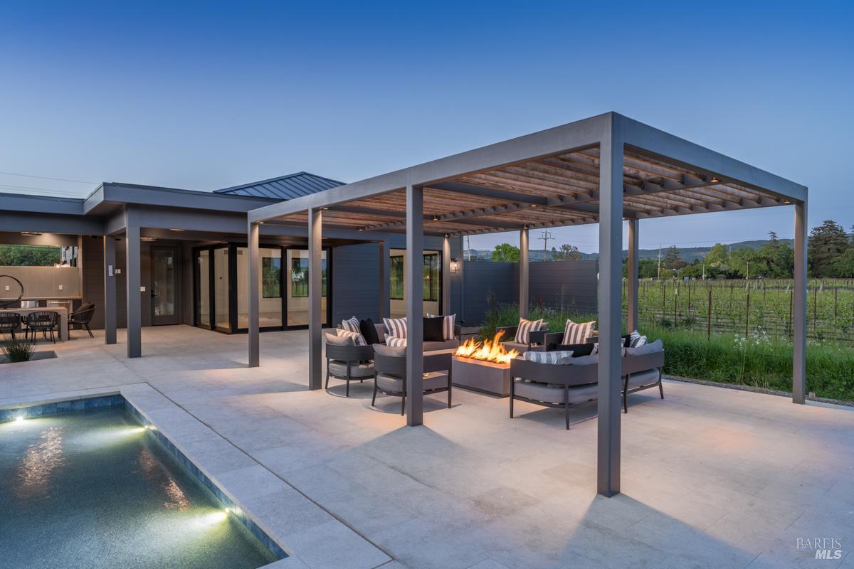 601 Napa Road Sonoma, CA 95476 - Photo 12 of 14 a view of a patio with a table and chairs under an umbrella