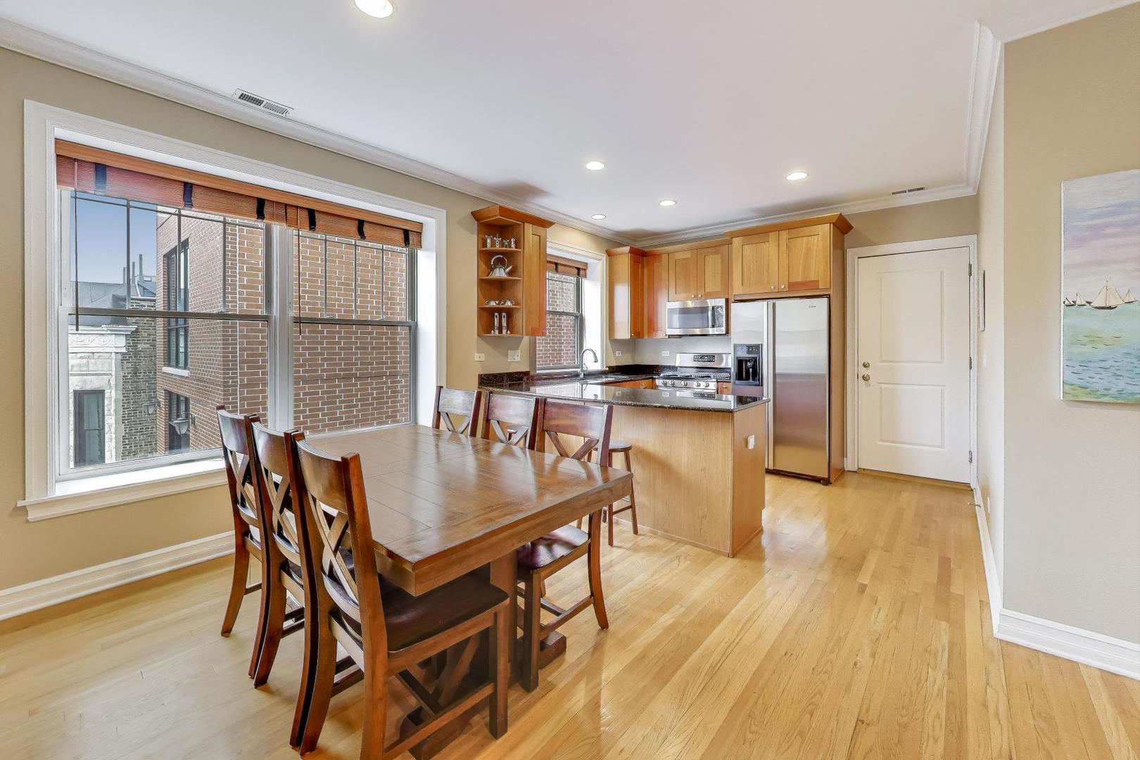 2711 North Mildred Avenue, Unit 3A Chicago, IL 60614 - Photo 12 of 27 a kitchen with a table chairs refrigerator and cabinets