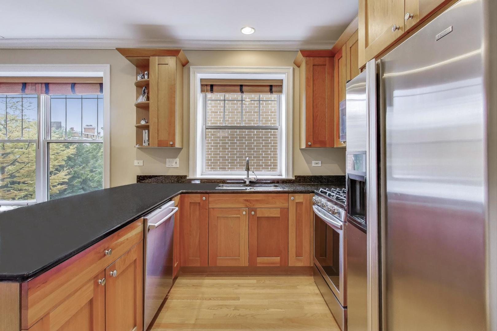 2711 North Mildred Avenue, Unit 3A Chicago, IL 60614 - Photo 16 of 27 a kitchen with stainless steel appliances granite countertop a refrigerator and a sink