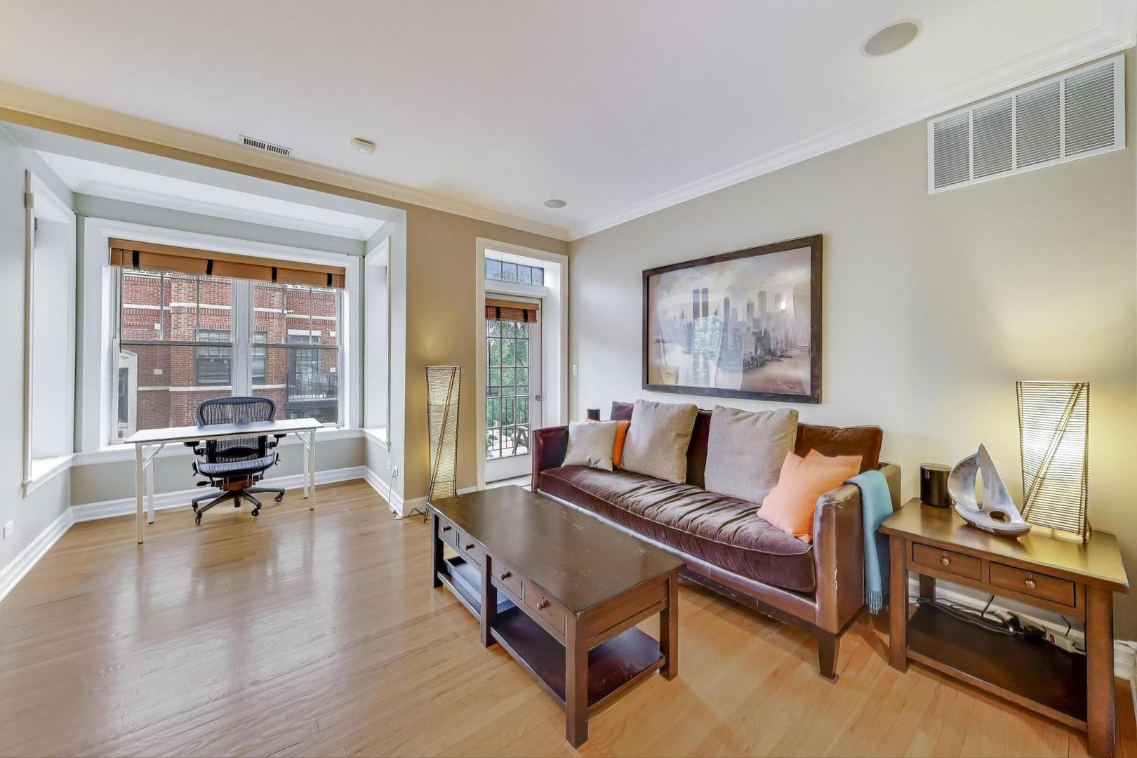 2711 North Mildred Avenue, Unit 3A Chicago, IL 60614 - Photo 6 of 27 a living room with furniture large window and a table