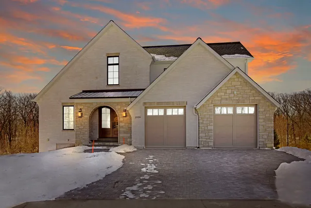 a view of a house with a yard and garage