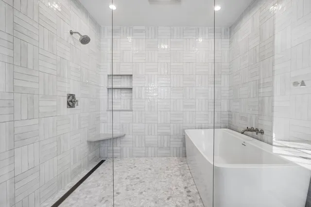 a bathroom with a bathtub and a shower