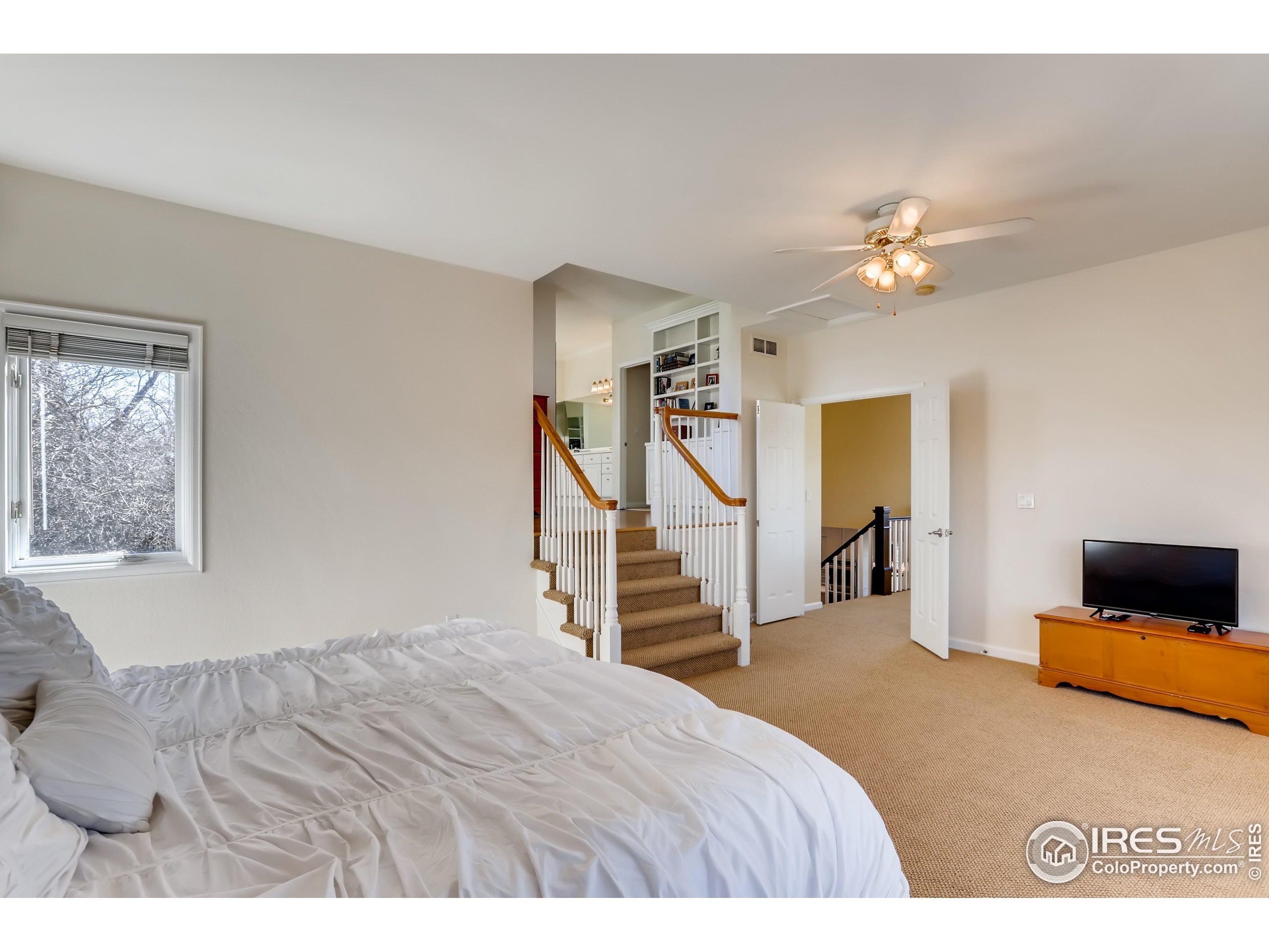 234 Mohawk Drive Boulder, CO 80303 - Photo 20 of 49 a bedroom with a bed and a chandelier