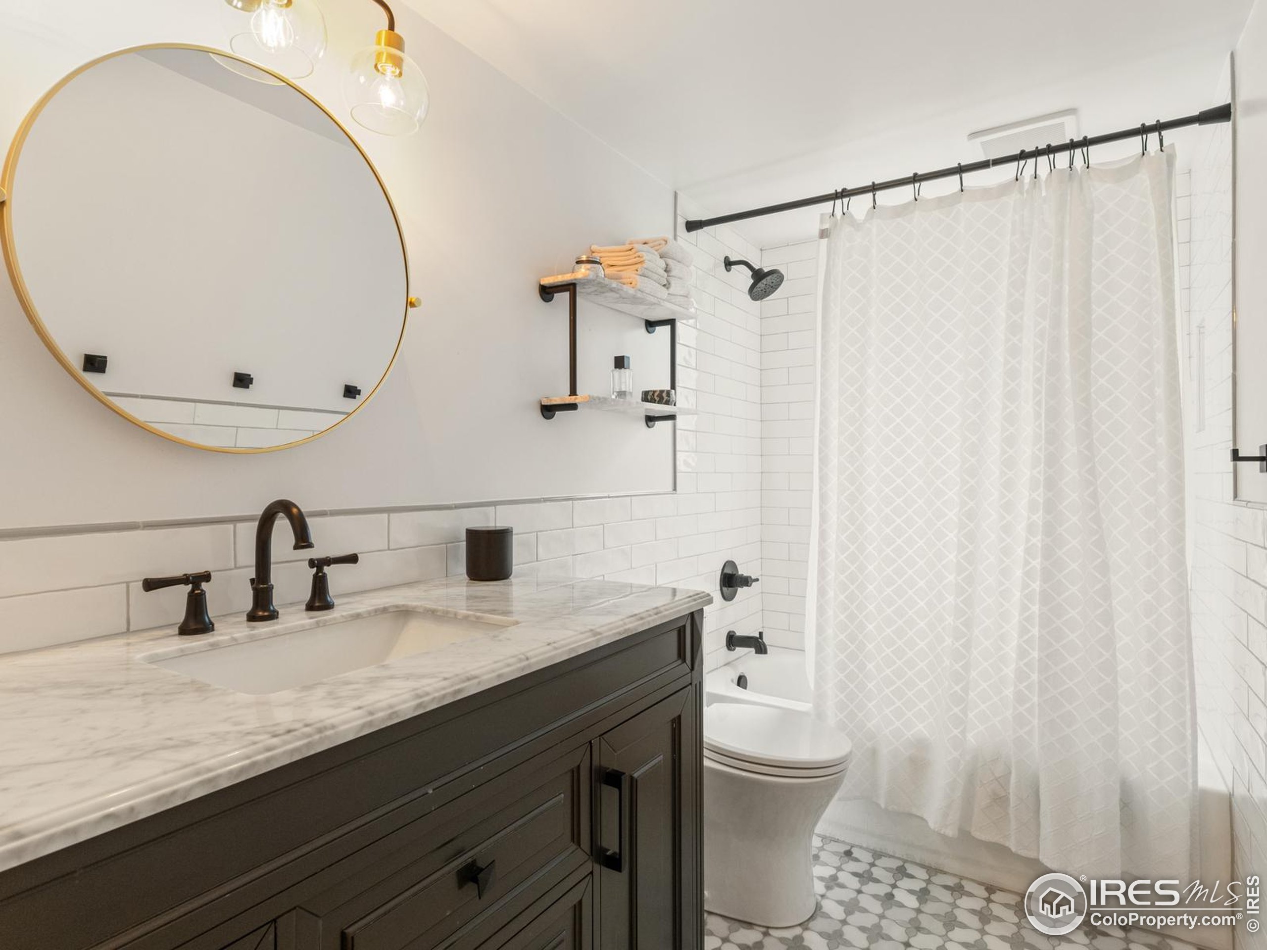 234 Mohawk Drive Boulder, CO 80303 - Photo 28 of 49 a bathroom with a granite countertop sink toilet and a mirror