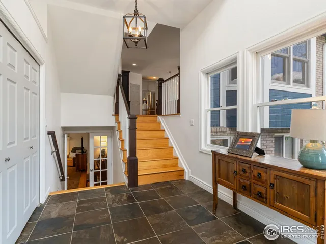 a view of a hallway with fireplace and chandelier