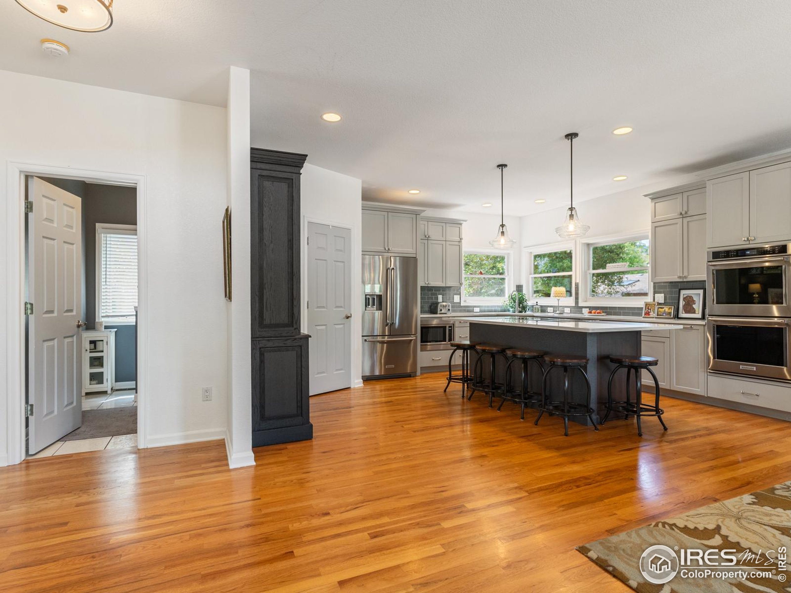 234 Mohawk Drive Boulder, CO 80303 - Photo 10 of 49 a kitchen with stainless steel appliances kitchen island granite countertop a refrigerator and a stove top oven
