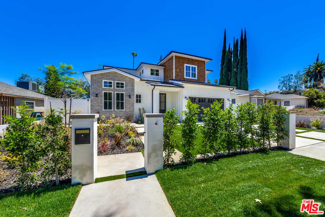 16700 Addison Street Encino, CA 91436 - Photo 2 of 53 a front view of a house with garden