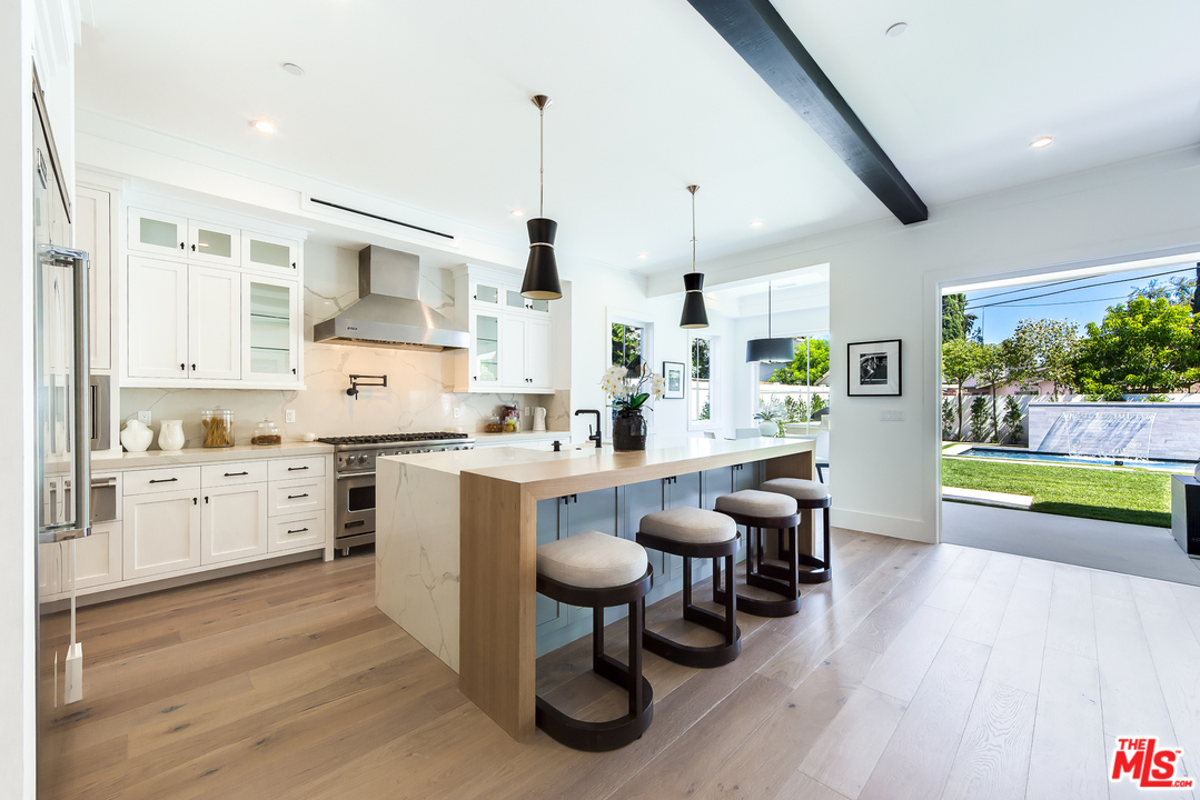 16700 Addison Street Encino, CA 91436 - Photo 12 of 53 a large kitchen with lots of counter space and stainless steel appliances