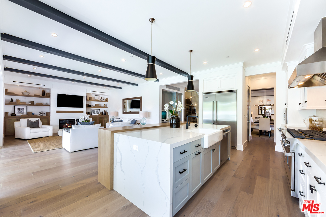 16700 Addison Street Encino, CA 91436 - Photo 15 of 53 a large white kitchen with lots of counter top space
