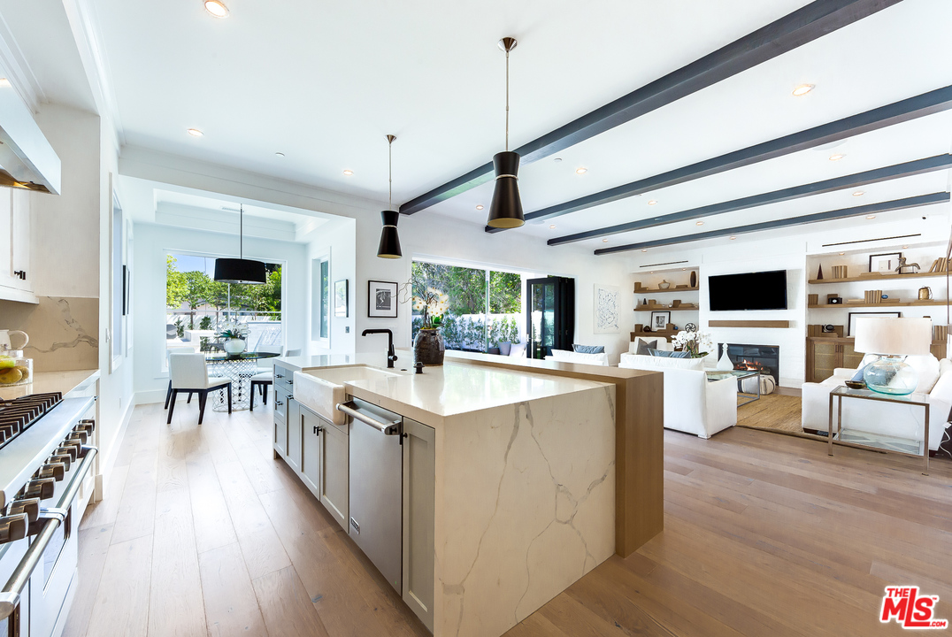 16700 Addison Street Encino, CA 91436 - Photo 16 of 53 a kitchen with counter top space and living room