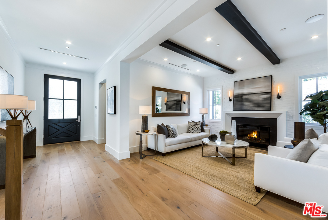 16700 Addison Street Encino, CA 91436 - Photo 3 of 53 a living room with furniture and a fireplace