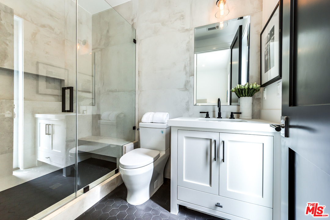 16700 Addison Street Encino, CA 91436 - Photo 26 of 53 a spacious bathroom with a sink a toilet and shower
