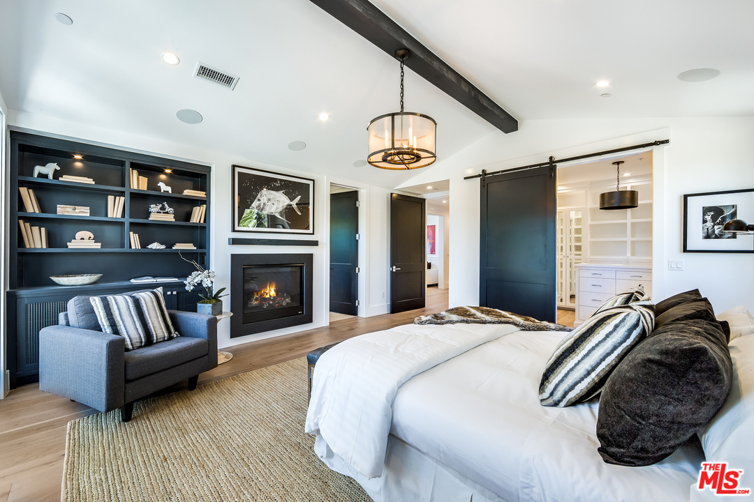 16700 Addison Street Encino, CA 91436 - Photo 33 of 53 a bedroom with furniture and a fireplace