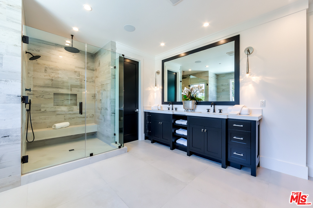 16700 Addison Street Encino, CA 91436 - Photo 36 of 53 a bathroom with a sink double vanity and a shower