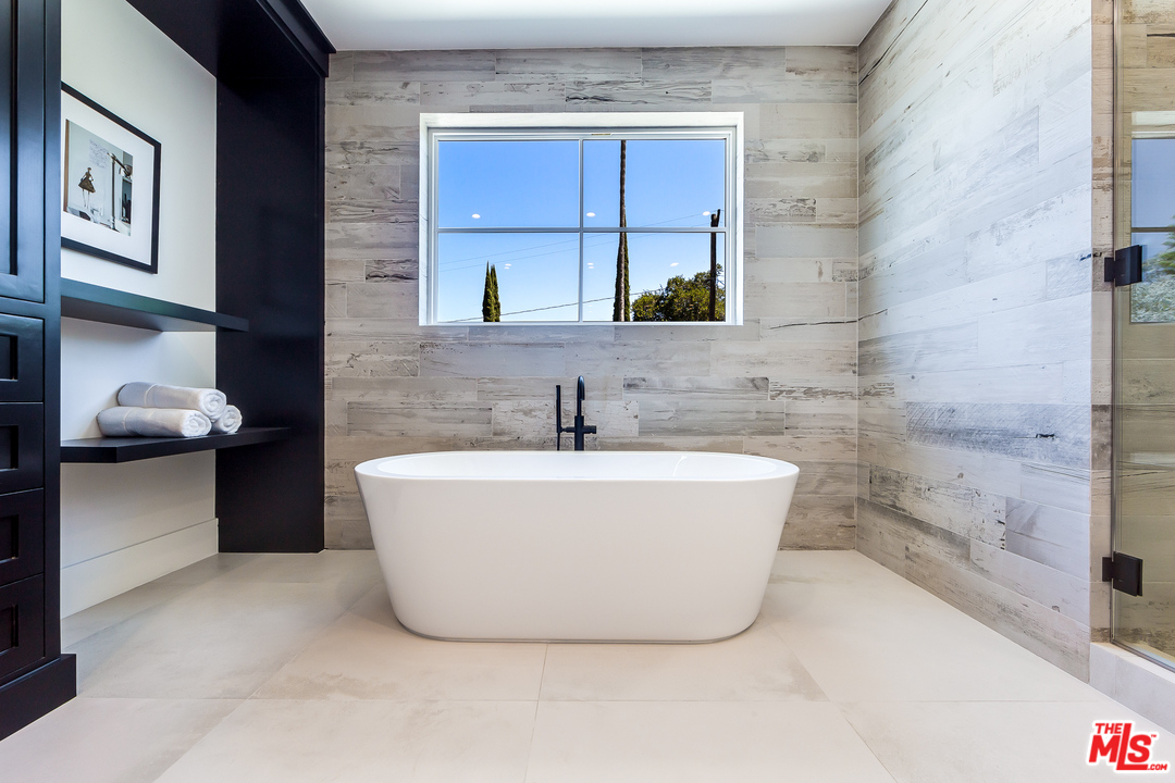 16700 Addison Street Encino, CA 91436 - Photo 38 of 53 a white bath tub sitting in a bathroom