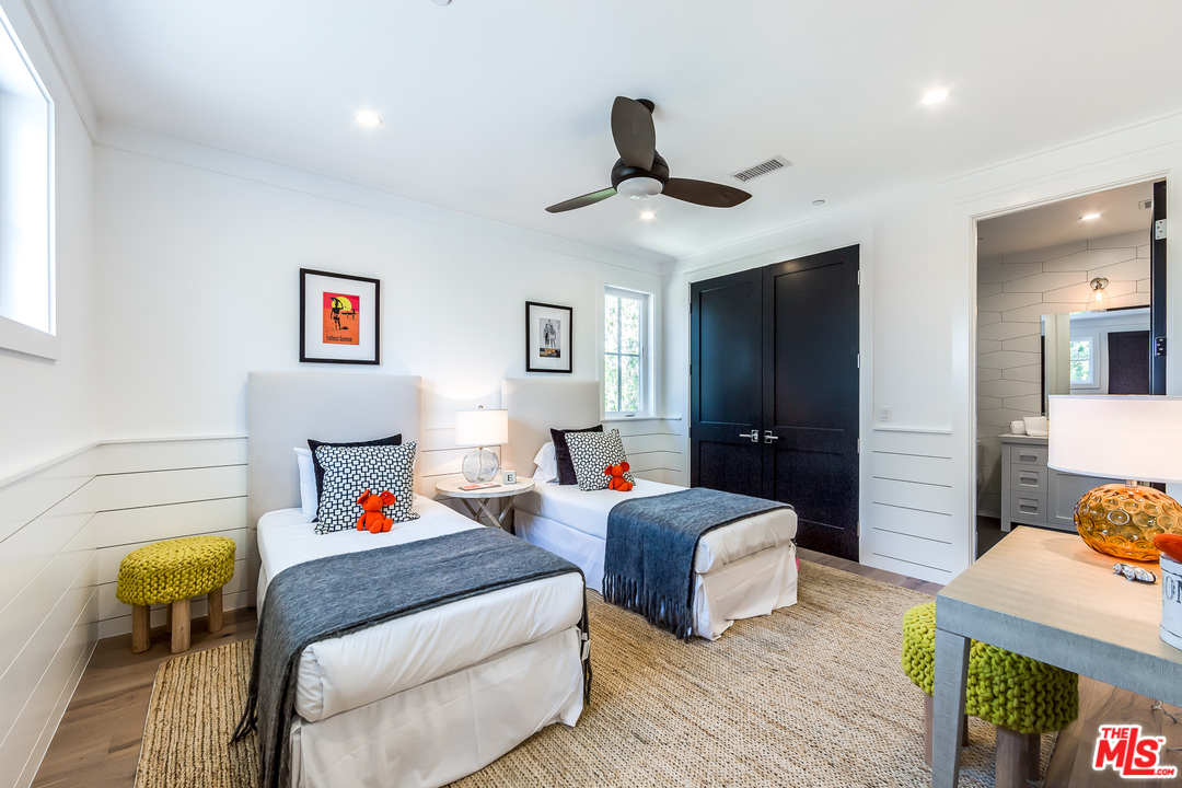 16700 Addison Street Encino, CA 91436 - Photo 46 of 53 a bedroom with a bed and wooden floor