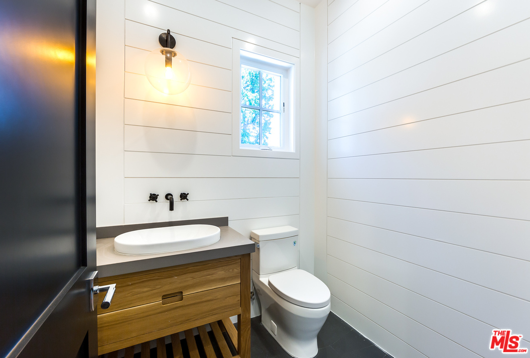 16700 Addison Street Encino, CA 91436 - Photo 6 of 53 a bathroom with a sink a toilet and shower