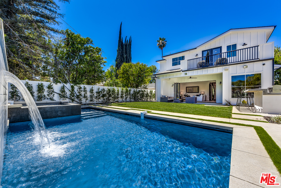 16700 Addison Street Encino, CA 91436 - Photo 51 of 53 a view of a house with swimming pool and sitting area