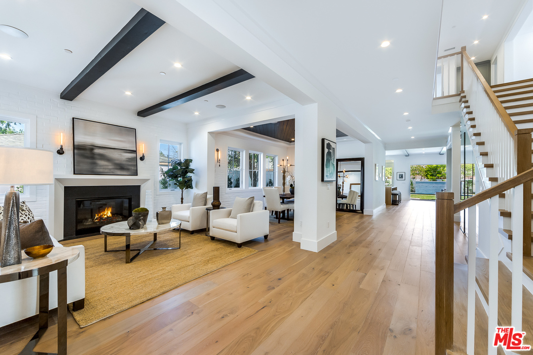 16700 Addison Street Encino, CA 91436 - Photo 7 of 53 a living room with furniture and a fireplace