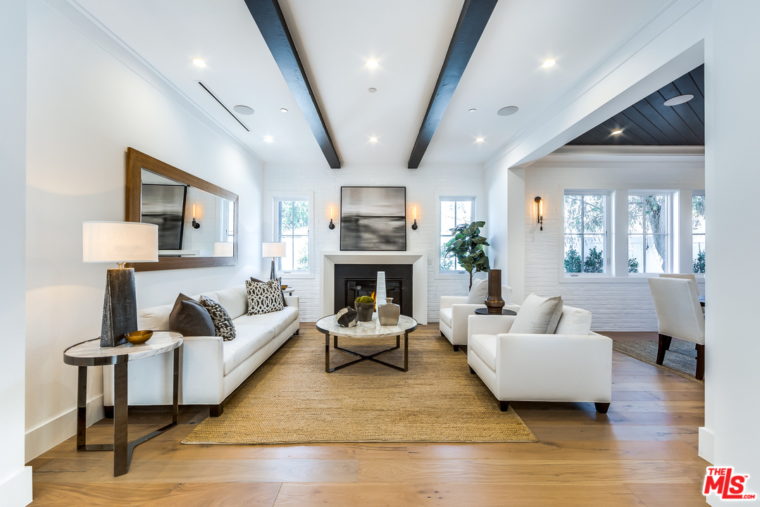 16700 Addison Street Encino, CA 91436 - Photo 8 of 53 a living room with furniture and a fireplace