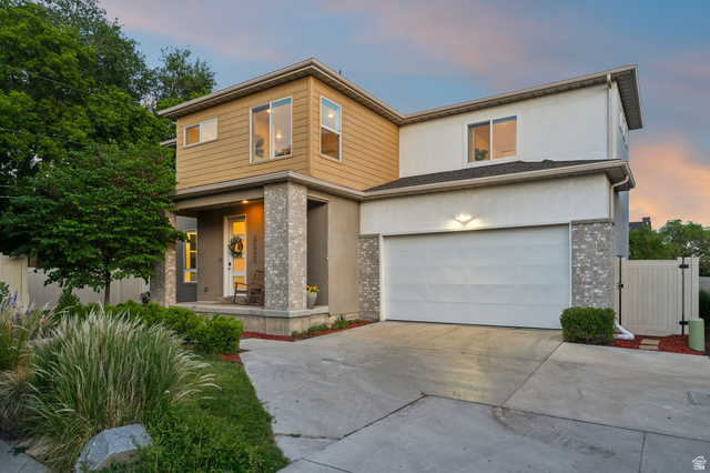4595 College Ridge Court Millcreek, UT 84117 - Photo 41 of 57 Contemporary multi-level residence featuring a two-car garage, partial stone veneer accents, and a covered front porch