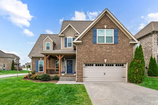 a front view of a house with a yard