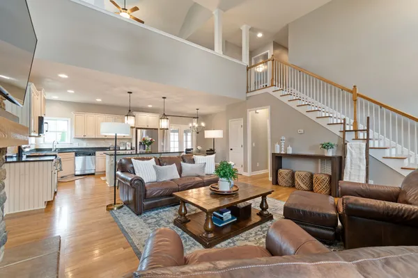 a living room with furniture kitchen view and a dining table