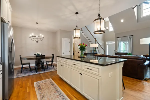 a kitchen with center island table and chairs in it