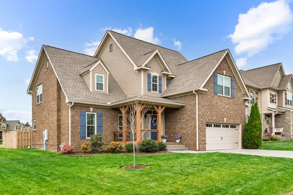 a front view of a house with a yard and garage