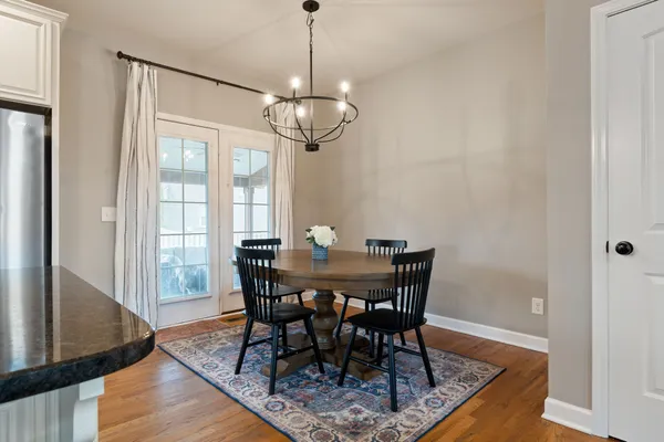 a view of a dining room with furniture window and wooden floor