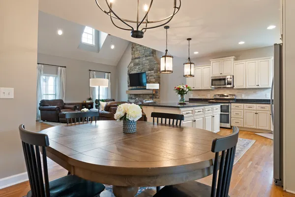 a kitchen with a dining table chairs and kitchen view