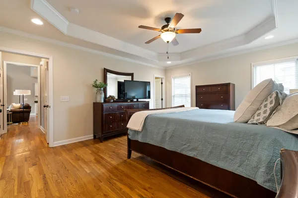 a spacious bedroom with a bed and a chandelier