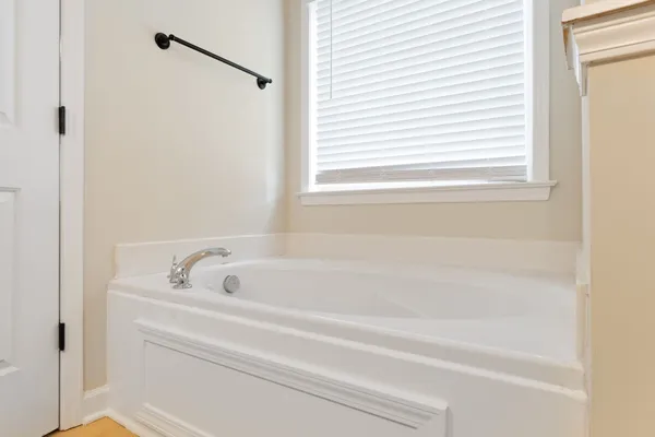 a bathroom with a tub and a window