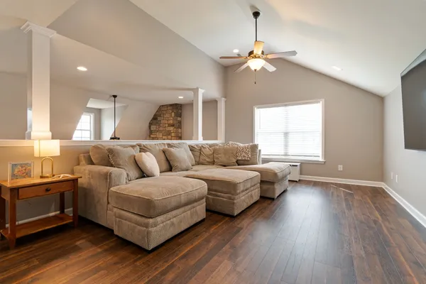 a living room with furniture and a chandelier