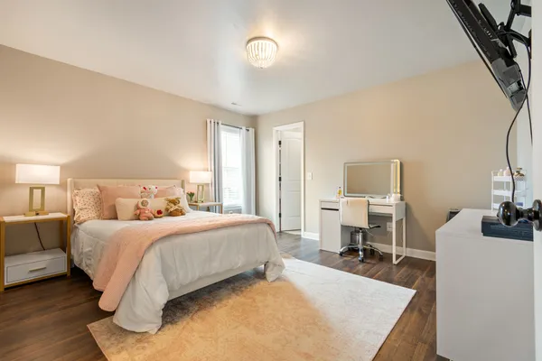 a bedroom with a bed and a table