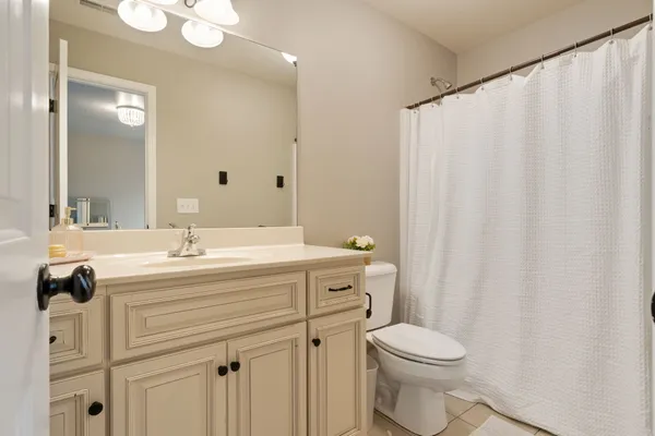 a bathroom with a sink a toilet and shower curtain