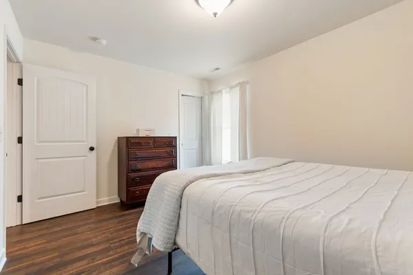 a bedroom with a bed and a dresser