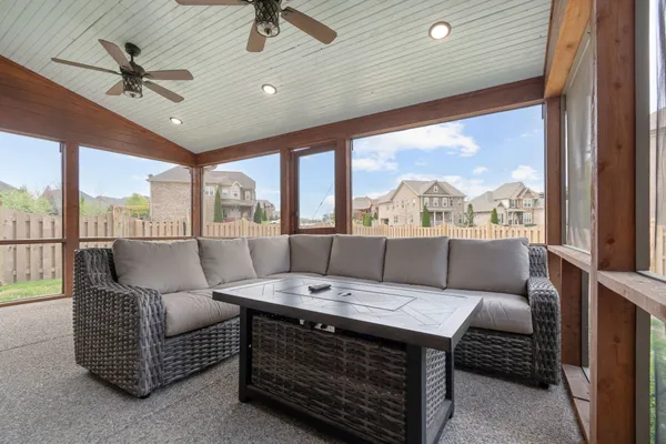 a living room with furniture a large window