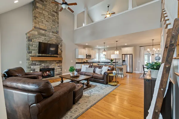 a living room with furniture wooden floor and a flat screen tv