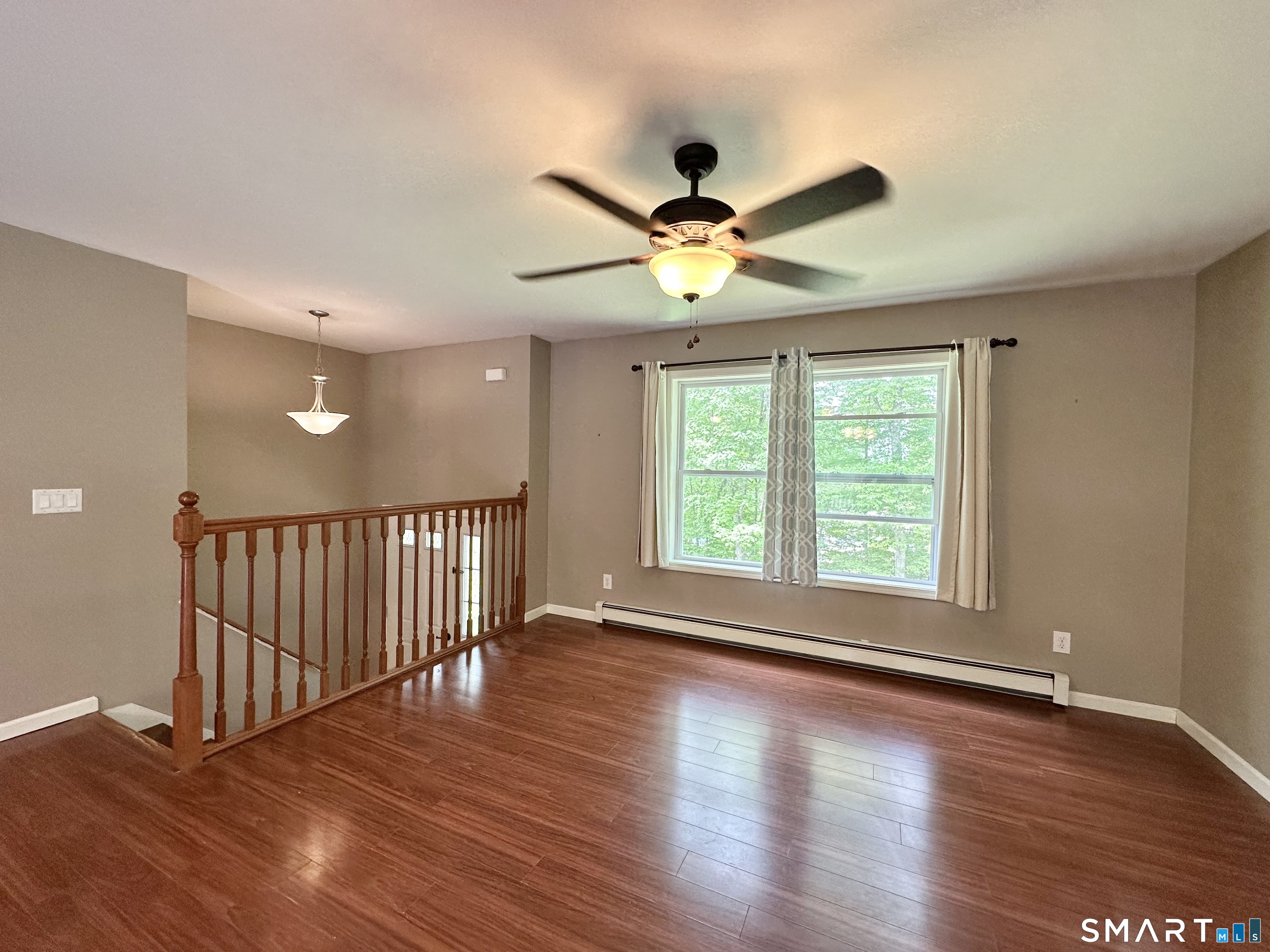 116 Tatnic Hill Road Brooklyn, CT 06234 - Photo 12 of 27 a view of an empty room with wooden floor and a window