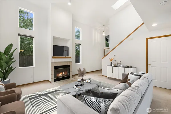 a living room with furniture a fireplace and a flat screen tv