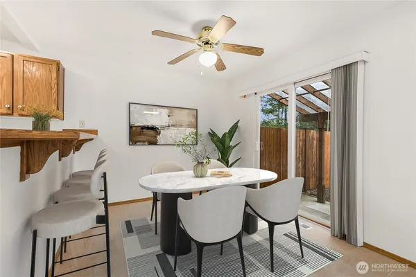 a view of a dining room with furniture and a potted plant