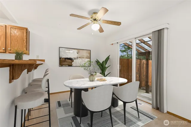 a view of a dining room with furniture and a potted plant
