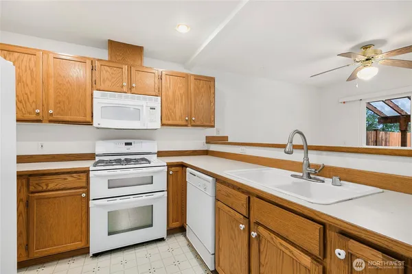 a kitchen with stainless steel appliances granite countertop a sink and cabinets