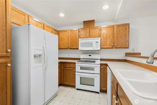 a kitchen with a refrigerator stove and sink