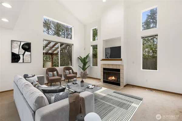 a living room with furniture a window and a fireplace