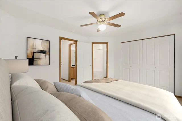 a bedroom with a large bed and a chandelier