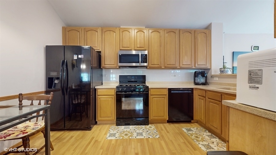 1725 Sienna Court Wheeling, IL 60090 - Photo 13 of 33 a kitchen with stainless steel appliances granite countertop a refrigerator stove top oven and sink